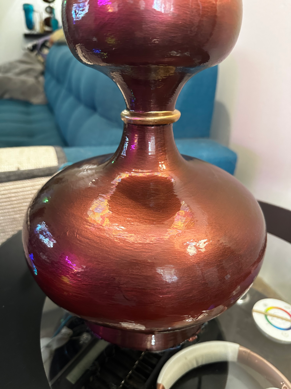 Close-up of the lamp base showing iridescent copper and rose metallic shift