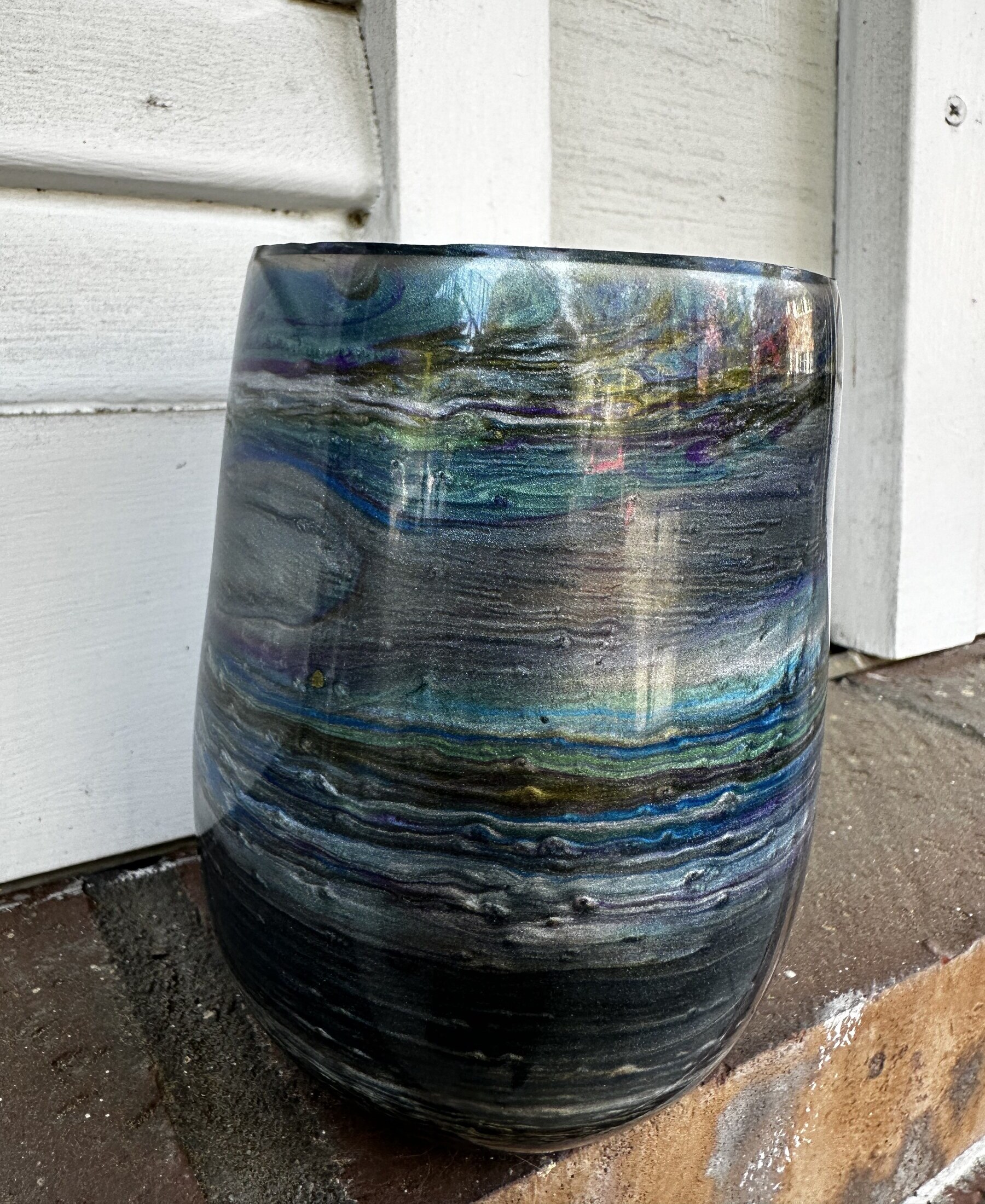 Resin and mica cup with geological banding on porch steps