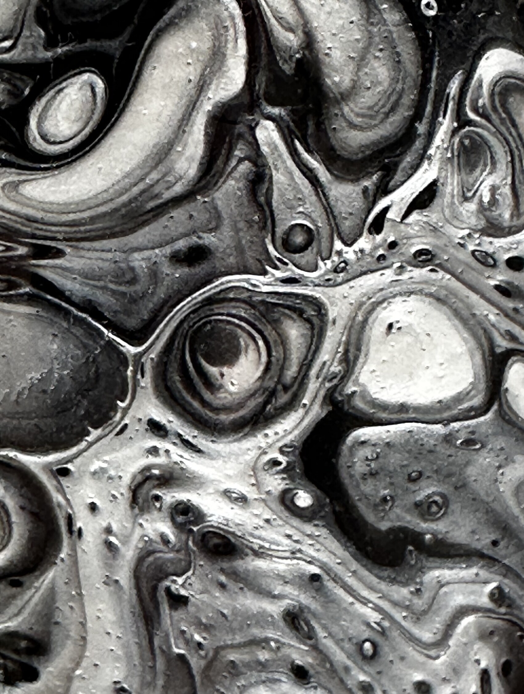 Close-up of the black and silver paint skin — swirling forms that read as smoke